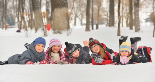 children playing in snow in winter